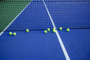 tennis balls and net on court