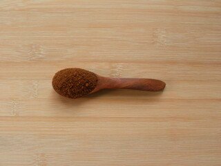 Instant coffee powder on wooden spoon