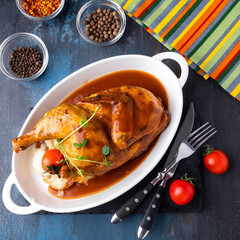 Baked chicken with mashed potato on a plate. Top view