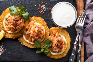 Potato pancakes with salmon and sour cream. Draniki. Top view