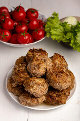 meatballs with tomato and lettuce on white background
