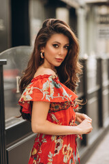 Woman in red dress poses on the street.Soft selective focus