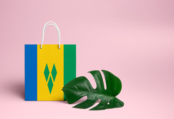 Saint Vincent And The Grenadines shopping concept. National cardboard shopping bag with monstera...