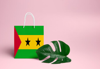 Sao Tome And Principe shopping concept. National cardboard shopping bag with monstera leaf and pink...