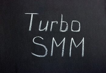 The inscription on the chalk board "Turbo SMM". Modern marketing technologies

