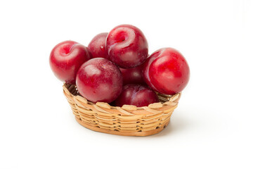Plums in a basket on a white background, isolate