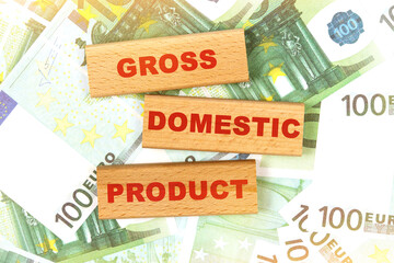Against the background of euro bills, the text is written on wooden blocks - gross domestic product
