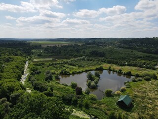 Aerial view of rural summer landscape with fields and forest on a sunny day 