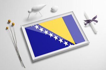 Bosnia Herzegovina flag in wooden frame on table. White natural soft concept, national celebration theme.
