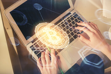 Double exposure of woman hands working on computer and blockchain theme hologram drawing. Top View....