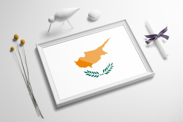 Cyprus flag in wooden frame on table. White natural soft concept, national celebration theme.