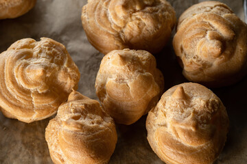Profiterole, cake blank, macro. Several profiteroles are lying on the table.