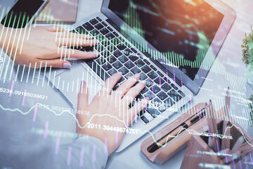 Multi exposure of woman hands typing on computer and forex chart hologram drawing. Stock market analysis concept.