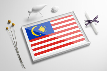 Malaysia flag in wooden frame on table. White natural soft concept, national celebration theme.