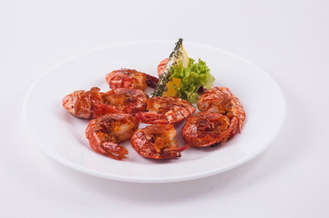 red shrimps with lemon on a white dish