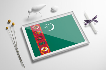 Turkmenistan flag in wooden frame on table. White natural soft concept, national celebration theme.