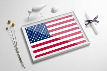 United States flag in wooden frame on table. White natural soft concept, national celebration theme.