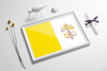 Vatican City flag in wooden frame on table. White natural soft concept, national celebration theme.