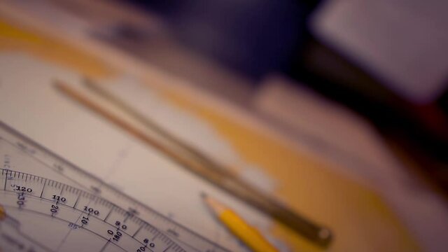 Plotting position on navigational chart at sea. Marine Map and ruler. Sowmotion shot
