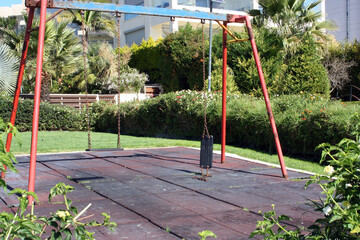 Dangerous broken swing on the playground, Limassol, Cyprus