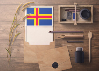 Aland Islands invitation, celebration letter concept. Flag with craft paper and envelope. Retro...