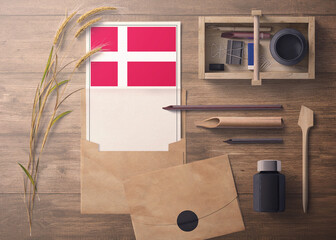 Denmark invitation, celebration letter concept. Flag with craft paper and envelope. Retro theme with divide, ink, wooden pen objects.