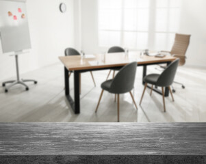 Empty stone surface and blurred view of modern office interior, closeup. Space for text