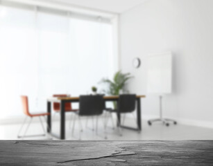 Empty stone surface and blurred view of modern office interior, closeup. Space for text