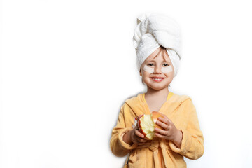Cute girl in a yellow bathrobe with eye patches