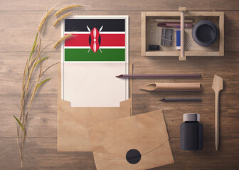 Kenya invitation, celebration letter concept. Flag with craft paper and envelope. Retro theme with divide, ink, wooden pen objects.
