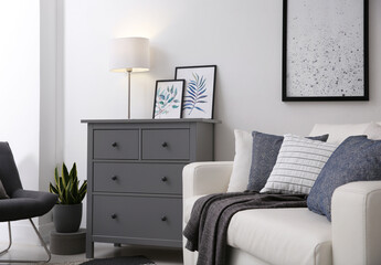 Modern room interior with grey chest of drawers