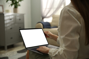 Woman using laptop at home, closeup. Space for design