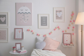 Fototapeta na wymiar Modern teenager's room interior with comfortable bed and beautiful pictures
