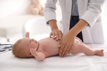 Obraz na płótnie Canvas Doctor examining cute baby indoors, closeup. Health care