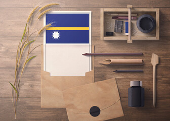 Nauru invitation, celebration letter concept. Flag with craft paper and envelope. Retro theme with divide, ink, wooden pen objects.