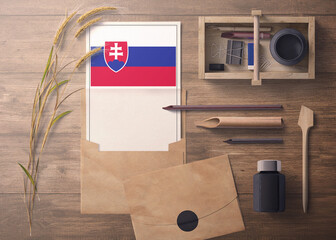 Slovakia invitation, celebration letter concept. Flag with craft paper and envelope. Retro theme with divide, ink, wooden pen objects.