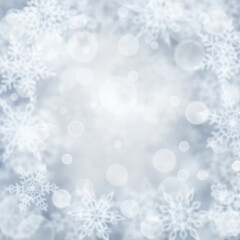 Christmas background of blurry snowflakes in gray colors