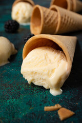 Vanilla ice cream melting with waffle cones with berries with creative light, bright summer mood