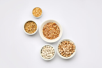 Different raw legumes on white background