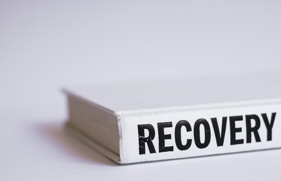Self-help white book with the word "recovery" written on it on a white background. The importance of mental health and healing