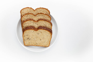 Multigrain bread slices on white oval plate on white background