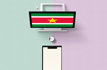 Suriname national flag on computer screen top view, cupcake and empty note paper for planning. Minimal concept with turquoise and purple background.