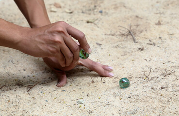 play glass marble on sandy ground