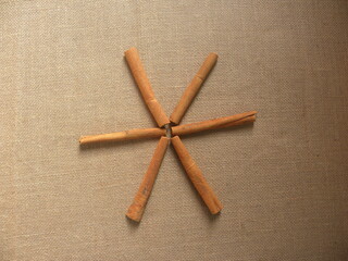 Orange color raw dried Cinnamon sticks arranged