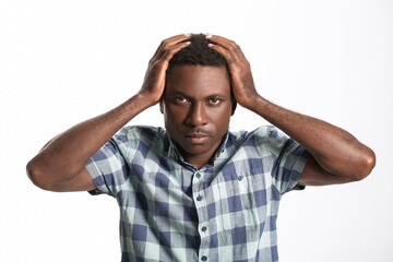 Sad African-American man on white background. Stop racism