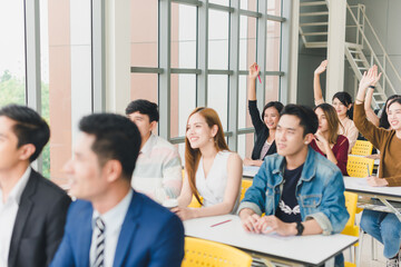 Fototapeta premium Asian male speaker is speaking at seminars and workshops to the people in the meeting. Those attending the meeting raised their hands to ask questions.