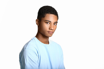 Sad African-American teenage boy on light background. Stop racism