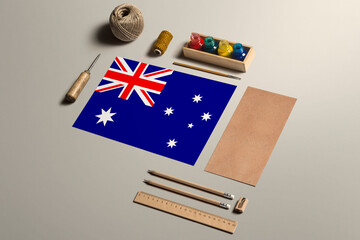 Fototapeta na wymiar Australia calligraphy concept, accessories and tools for beautiful handwriting, pencils, pens, ink, brush, craft paper and cardboard crafting on wooden table.