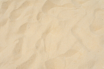 Fototapeta na wymiar Closeup of sand texture in summer sun