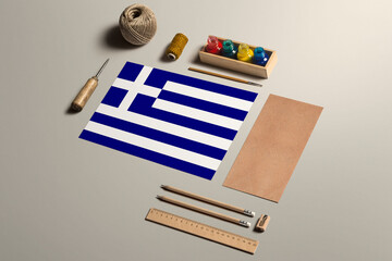Fototapeta na wymiar Greece calligraphy concept, accessories and tools for beautiful handwriting, pencils, pens, ink, brush, craft paper and cardboard crafting on wooden table.